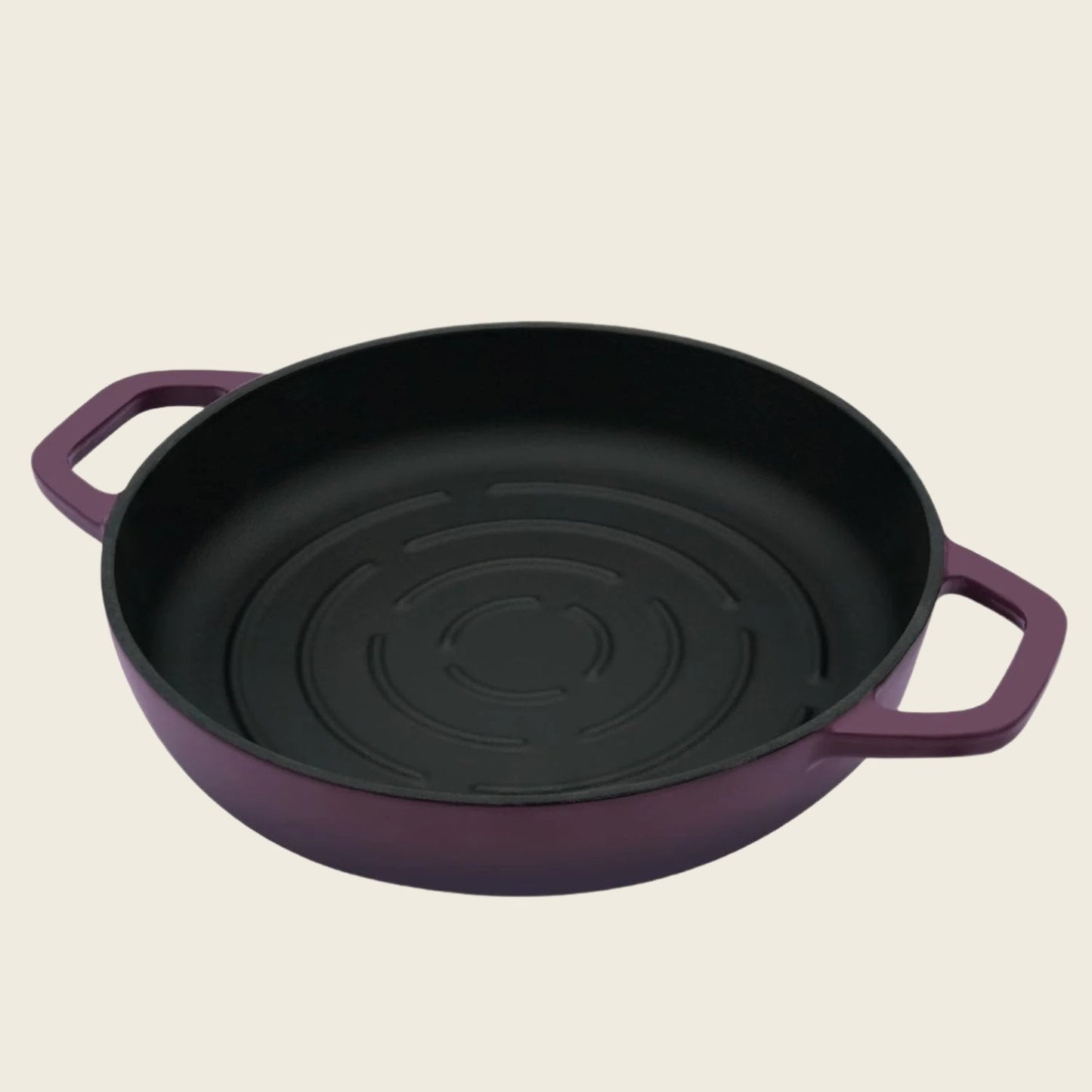 Purple cast iron bread loaf pan with black interior on a beige background
