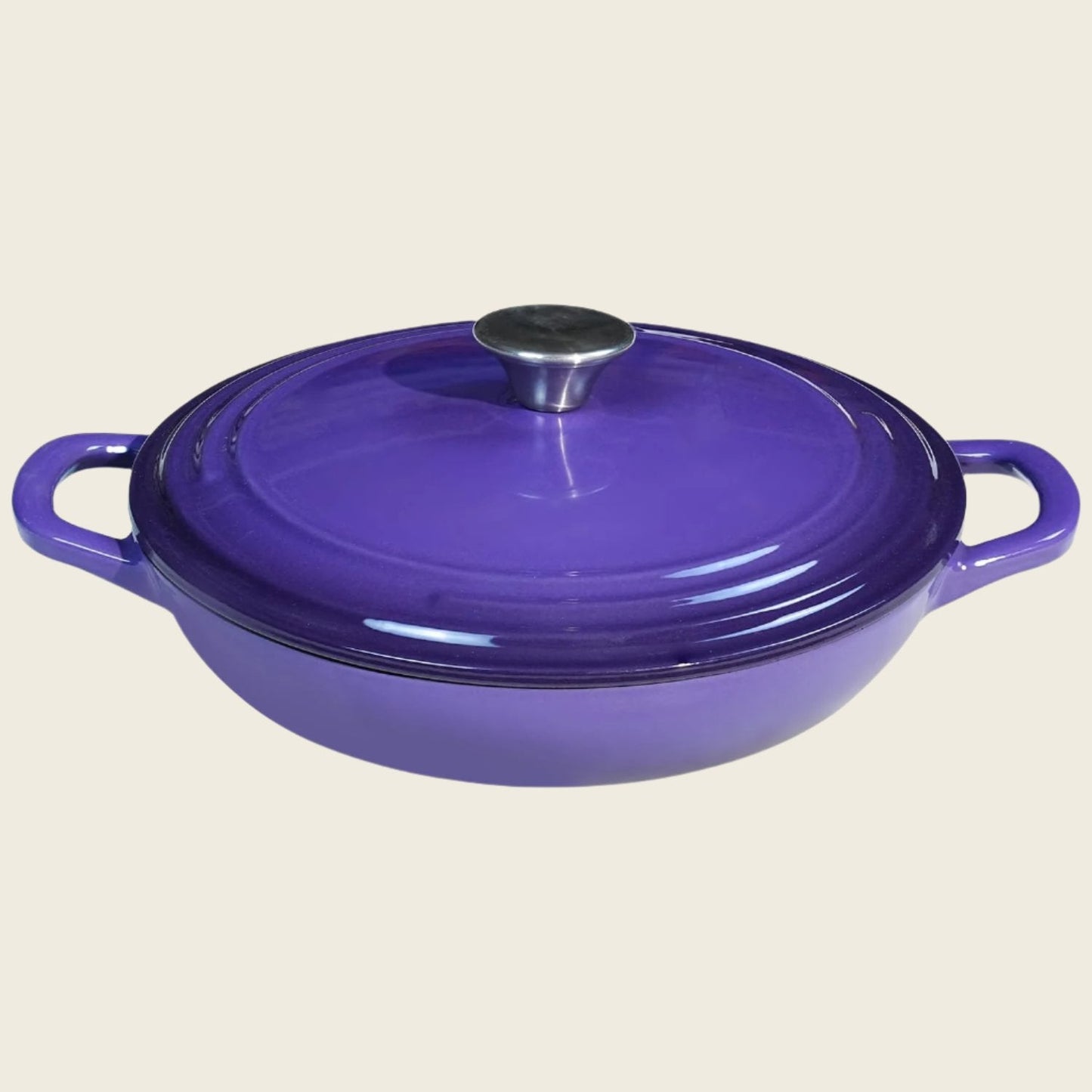 A purple enameled cast iron braiser with a lid, featuring a round shape and two handles.