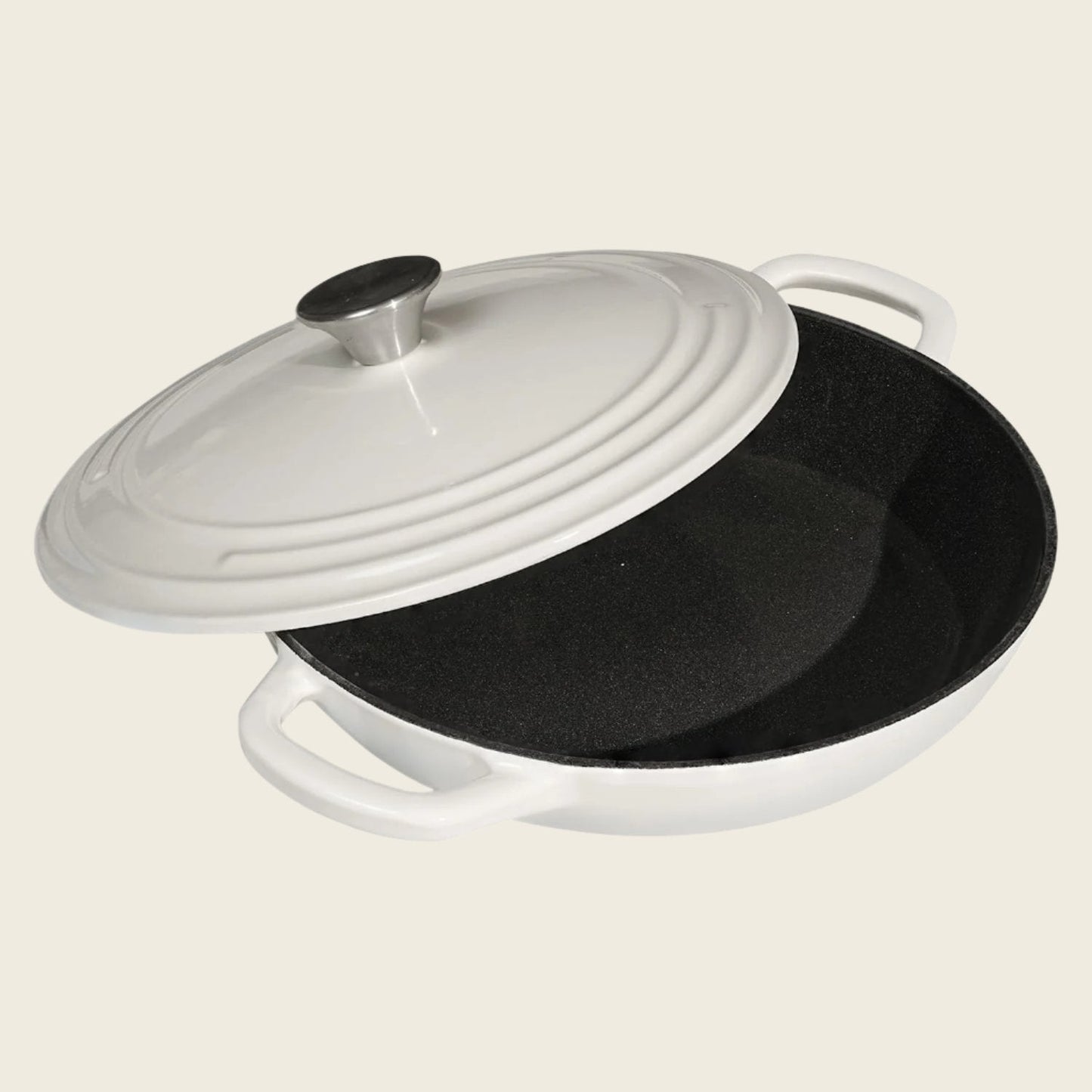 White enameled cast iron casserole dish with a lid on a beige background