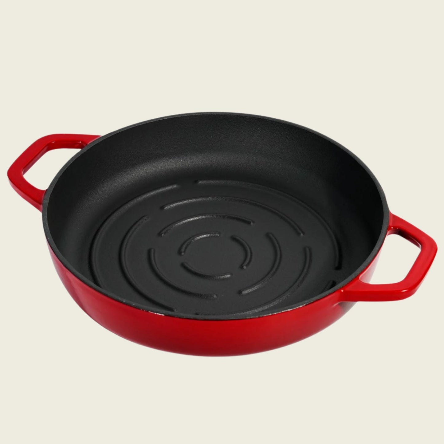 Red cast iron bread baker with black interior on a beige background