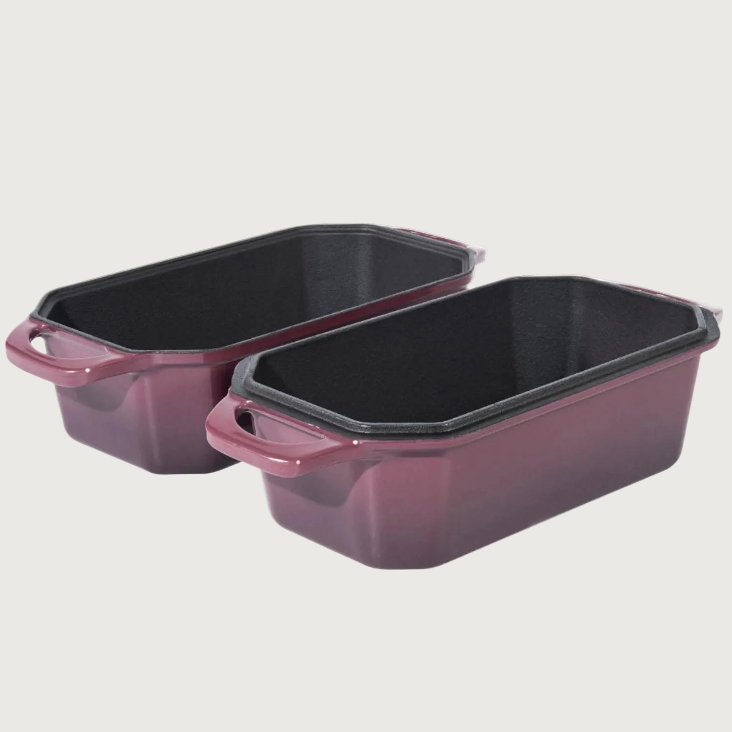 Two purple baking dishes with black interior on a beige background