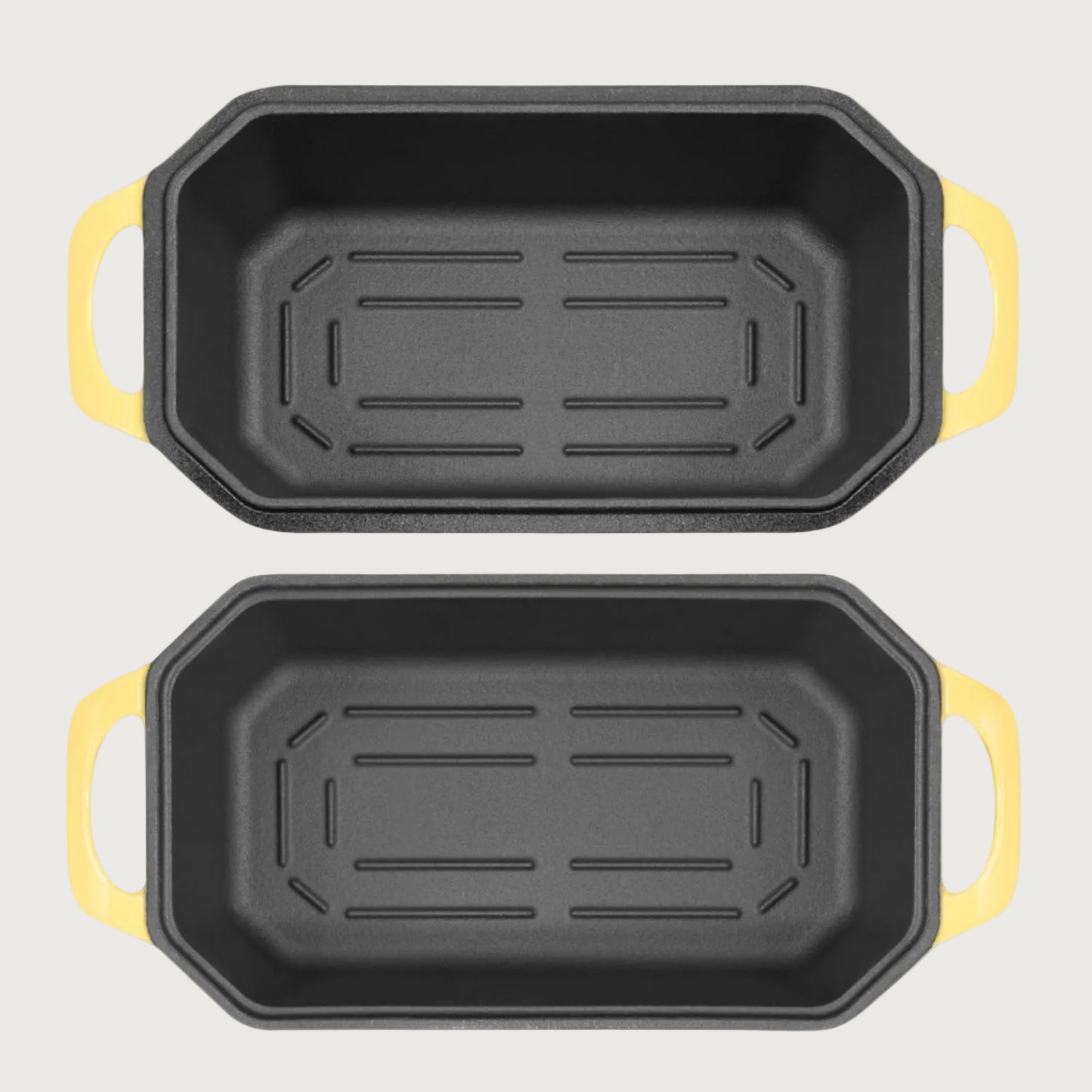 Two loaf pans with yellow handles on a beige background