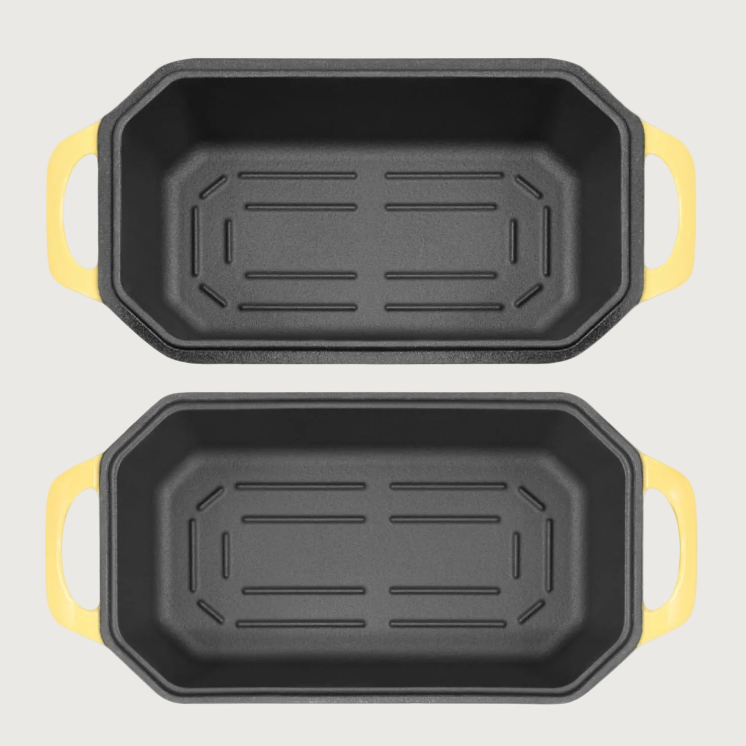 Two loaf pans with yellow handles on a beige background