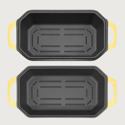 Two loaf pans with yellow handles on a beige background