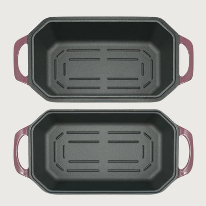 Two black rectangular baking pans with purple handles on a beige background