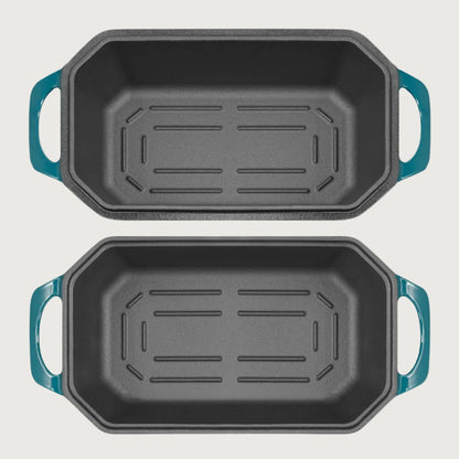 Two black roasting pans with blue handles on a beige background
