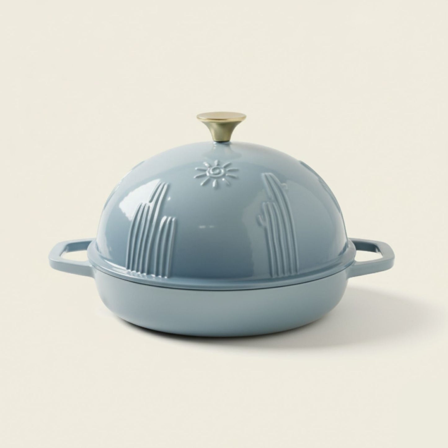 Light blue cast iron Dutch oven with lid on a beige background