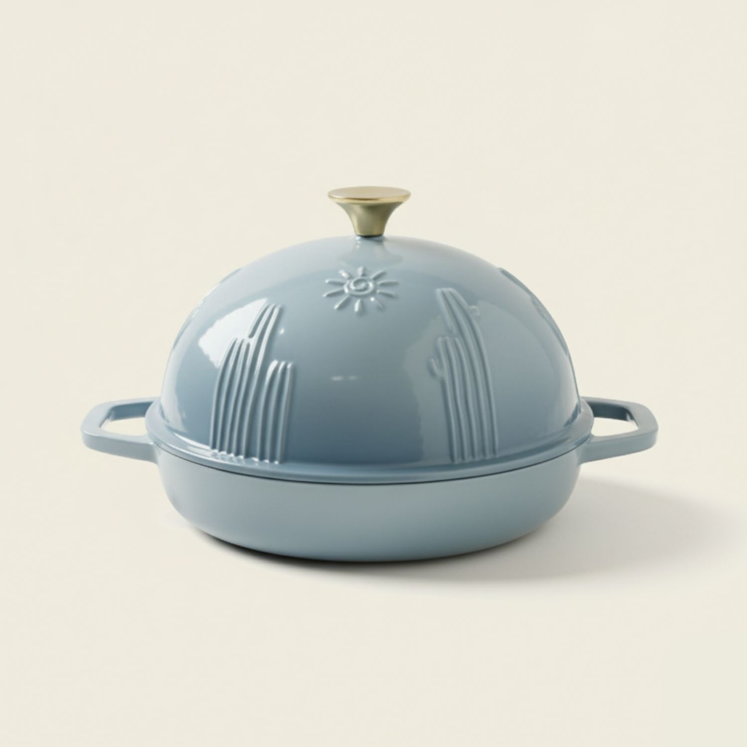 Light blue cast iron Dutch oven with lid on a beige background