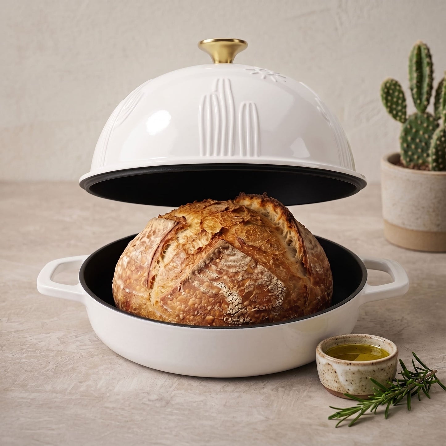 Enamelled cast iron Dutch oven in pearl white, open with sourdough loaf inside