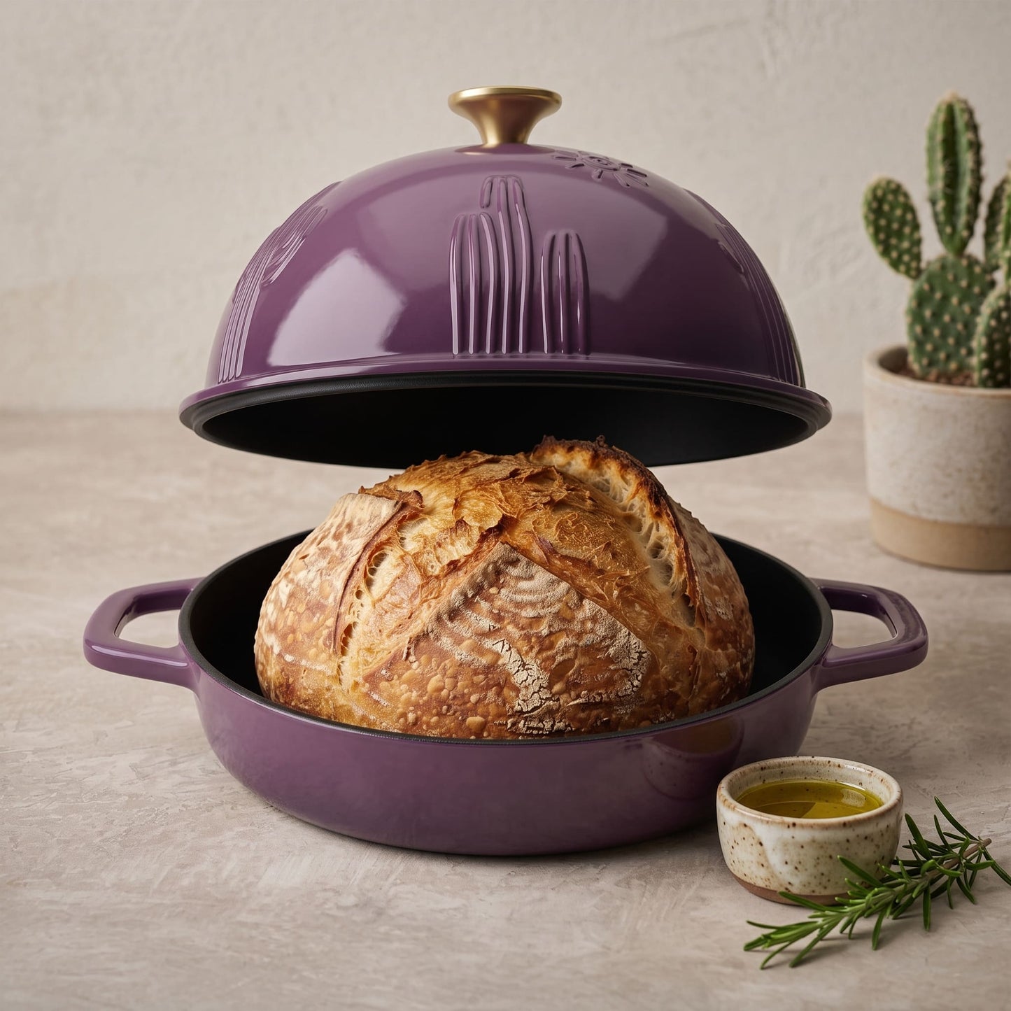 Enamelled cast iron Dutch oven in plum purple, open with sourdough loaf inside