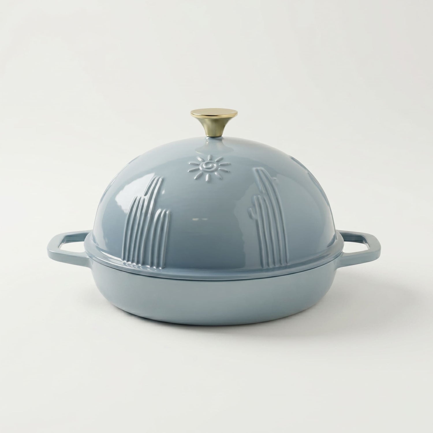 Blue enameled cast iron dutch oven bread pan with lid on a white background