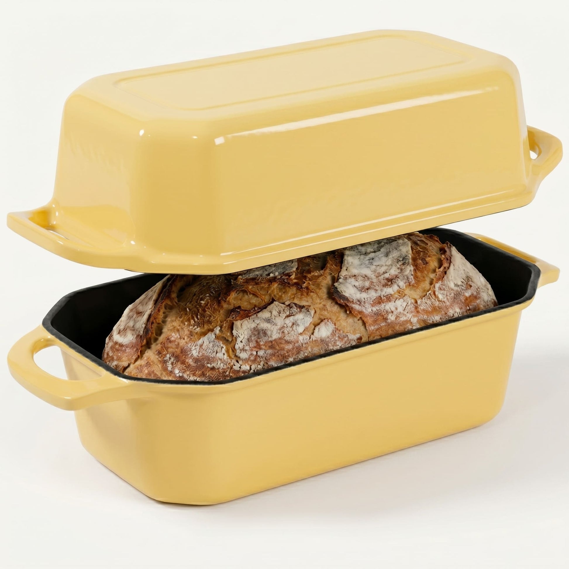 Yellow bread loaf pan with a loaf of bread inside on a white background