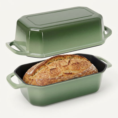 Green bread loaf pan with a loaf of bread inside on a white background