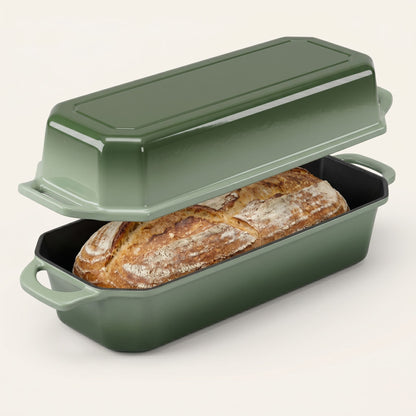 Green bread loaf pan with a loaf of bread inside on a white background