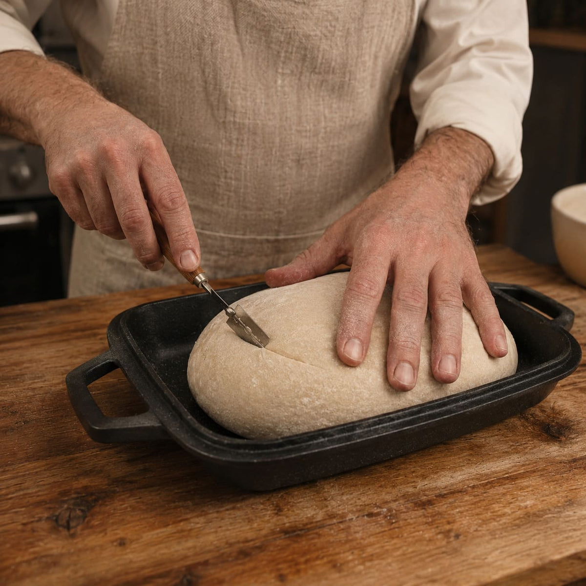 Oval bread pan with raw dough being prepared Black (Pre-Seasoned)