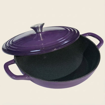 Purple cast iron skillet with lid on a beige background