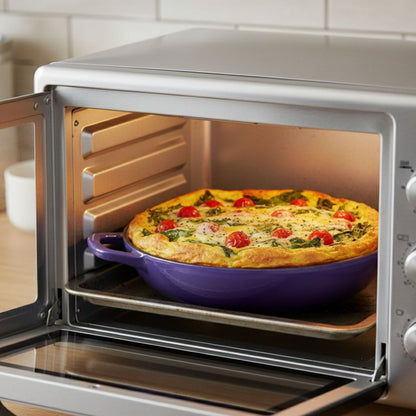 Toaster oven with a dish of quiche inside, on a kitchen counter.