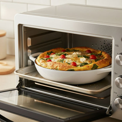 Omelette cooking in a toaster oven with visible ingredients like tomatoes and spinach.