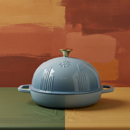 Blue dome-shaped dutch oven on a multicolored background