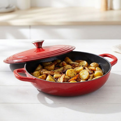 Red cast iron skillet with roasted potatoes on a white surface