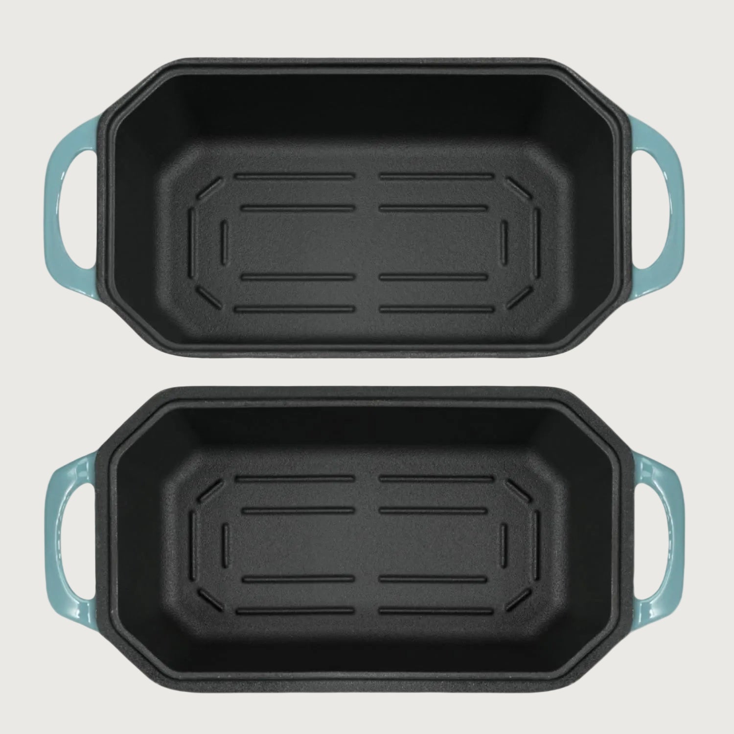 Two rectangular baking loaf pans with blue handles on a white background