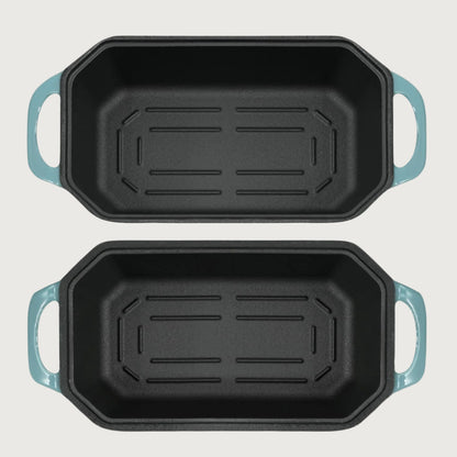 Two rectangular baking loaf pans with blue handles on a white background