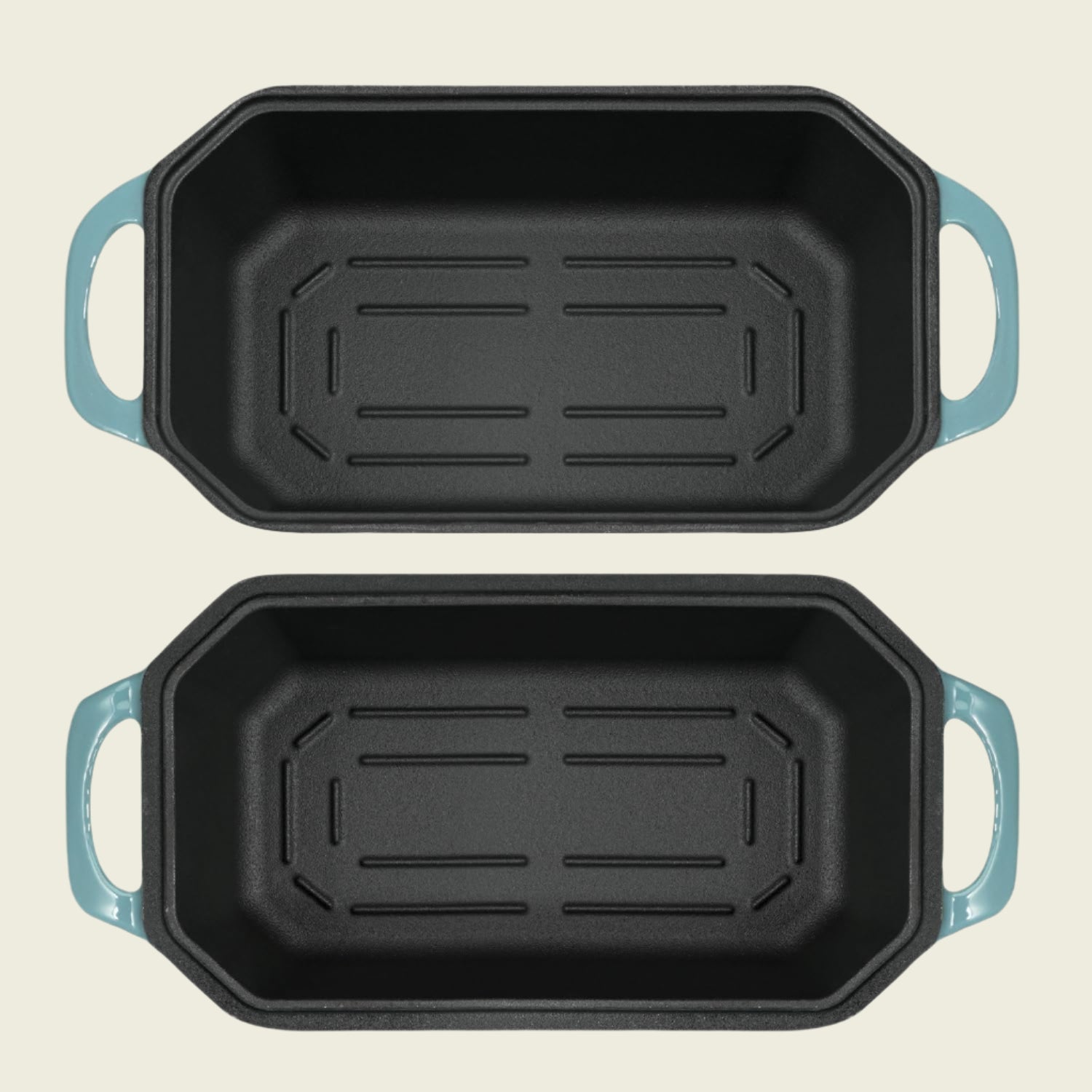 Two black rectangular baking pans with blue handles on a white background