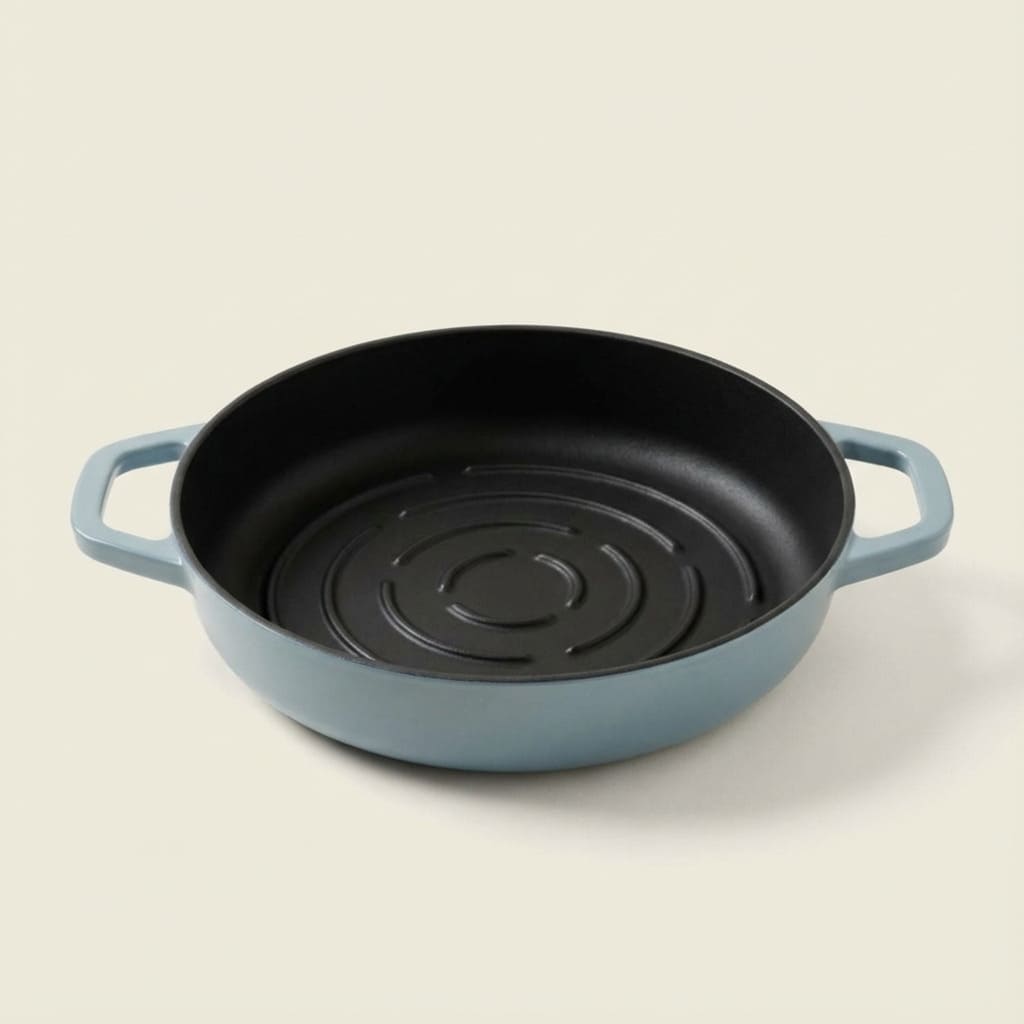 Blue cast iron bread pan with black interior on a beige background